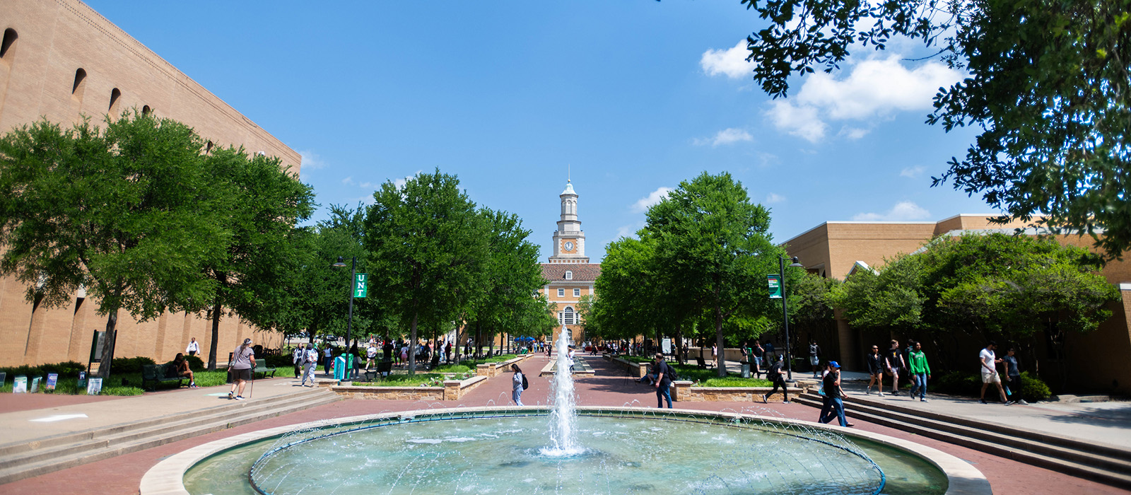 Students walking across the UNT Library Mall